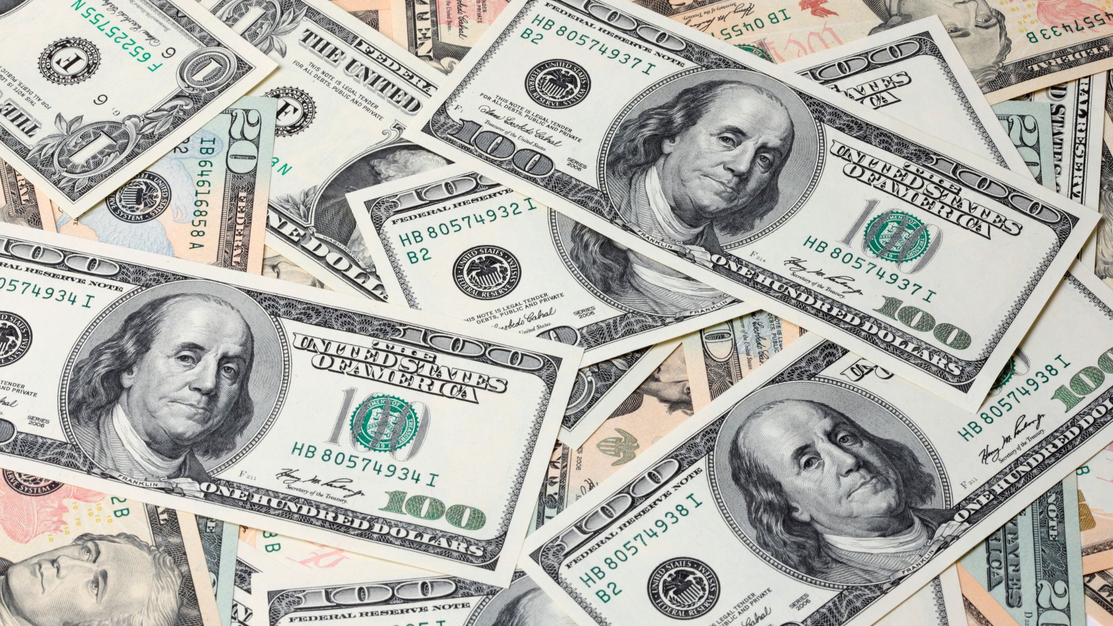 pile of cash showing large bills